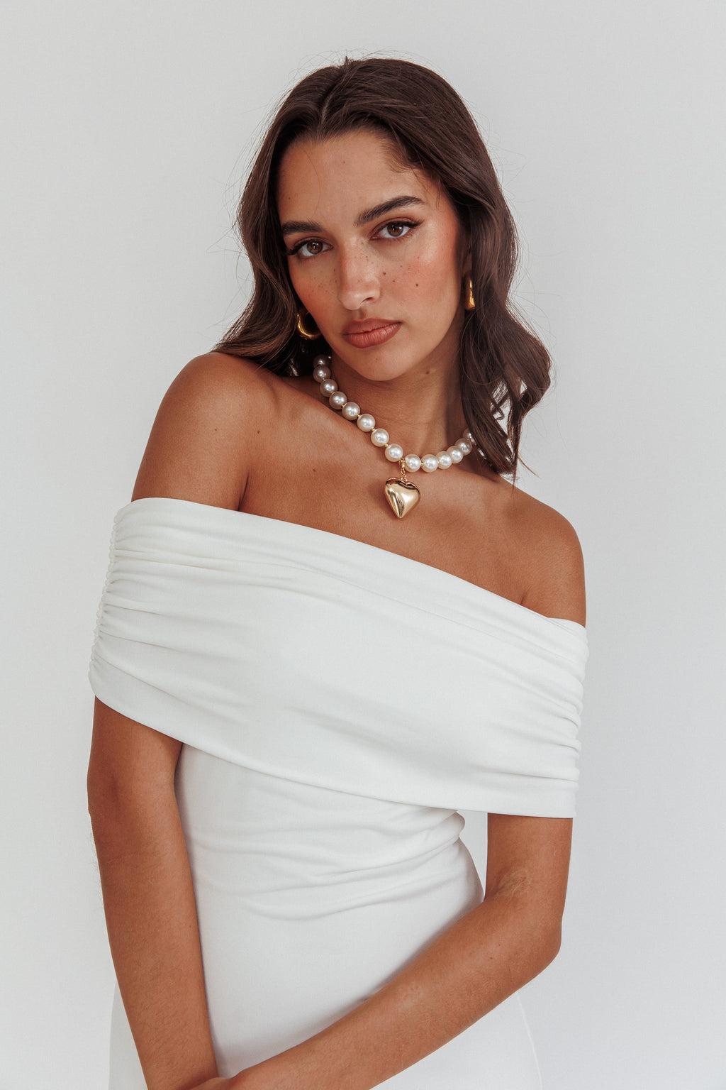 off the shoulder dress with necklace Women's Outfit: Black Off Shoulder Dress, Gold Pendant, Gold Bracelet