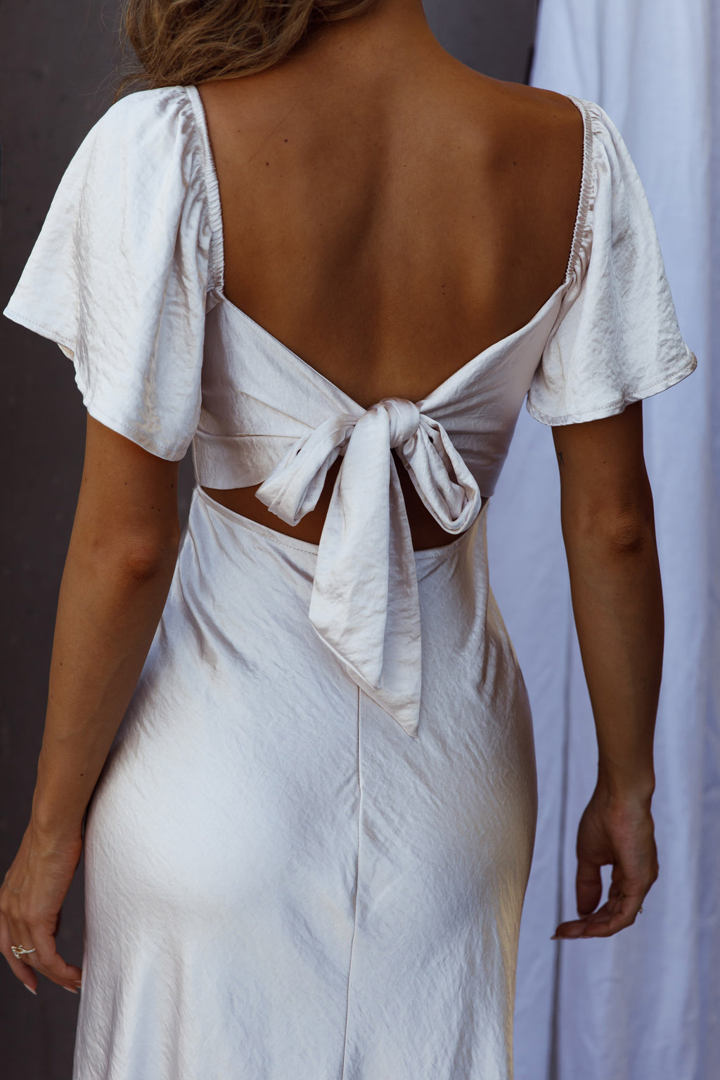 Grayson Tied Back Asymmetrical Midi Dress Champagne by Selfie Leslie